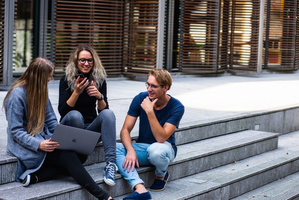 three persons sitting on the stairs talking with each other 1438072 1024x684 1